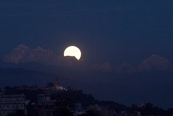 Seen after 70 years, the Supermoon rises from behind Gauri Shankar, also known as Chomo Tseringma, with a stunning view of Swayambunath in the foreground in Kathmandu on Monday.
