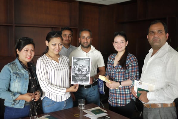 Arjun Bhadra Khanal (centre), Head of Business Support of Siddhartha Bank hands over air tickets to Nepali artists for their show in Japan on Friday.