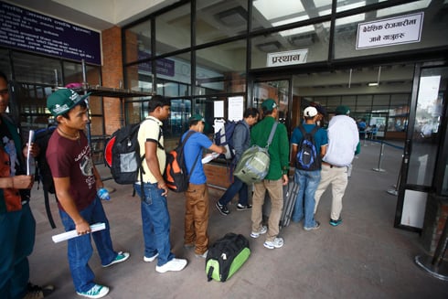 LEAVING HOME: Migrant workers queue up at the Kathmandu airport ahead of their flights. 1,500 leave the country each day for overseas work.