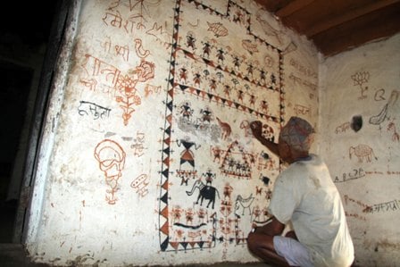 ART ATTACK: A man from Tharu community in Dang draws traditional Tharu paintings on the wall.