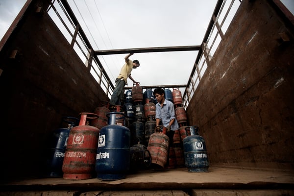 Workers offloading gas cylinders from a truck in Sanepa on Monday.