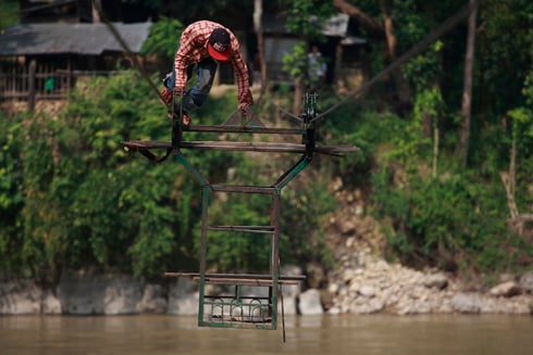 TO AND FRO: The operator of a wire bridge brings his trolley back across the Bheri River in Surkhet on Thursday.