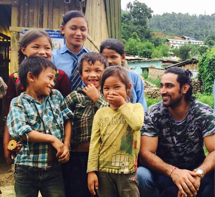 Bollywood actor Kunal Kapoor with children in an earthquake-hit village of Sindhupalchok district. Kapoor is in Nepal to observe Care Nepal's response to earthquake survivors.