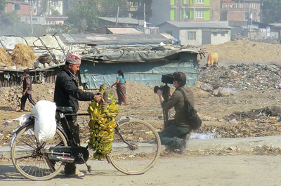 TWO JOBS: A filmmaker shoots footage of a slum area near the banks of the Bagmati while a fruit vendor goes to work.