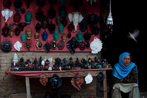 A woman waits for customers at her handmade clay craft stall in the porter square in Bhaktapur on Monday.