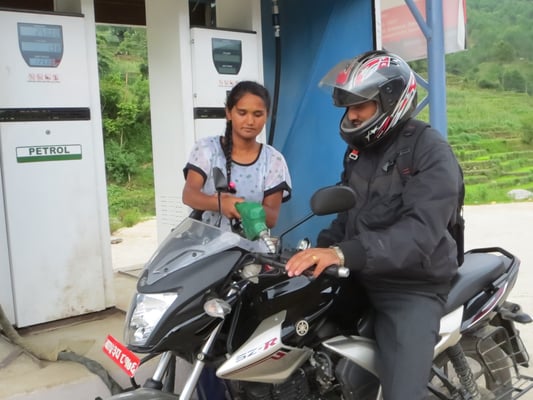 TANK FULL: A woman working at a petrol pump in Dolakha. In the absence of young men in villages women have taken up jobs in male dominated sectors.