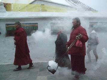 SPECIAL CONEXION: Buddhist pilgrims chant some mantras while walking around Boudhanath Stupa on Monday.