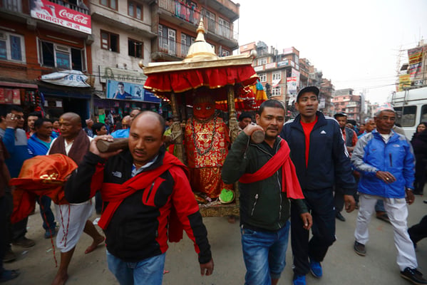 Devotees carry the idol of Rato Machindranath in a palanquin before the holy bath ritual at Lagankhel on Wednesday.