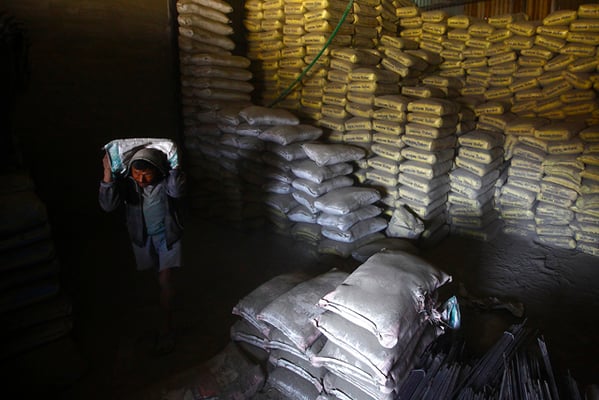 48-year-old Kamal Shrestha carries a sack of cement at a store in Thasikhel on Thursday. Shrestha was forced to move to Kathmandu from Sindhupalchok for work after he lost his home in last year’s earthquake.