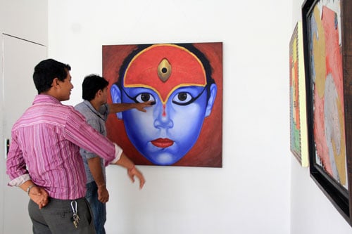 Visitors attend the exhibition 'Artists Unite' at Siddhartha Art Gallery on Tuesday. The exhibition is organised to raise funds for landslide and flood survivors in Western Nepal.