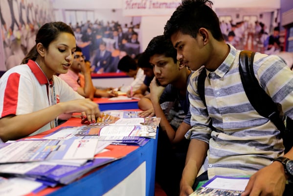 A participating college counsels students during the last day of Education Fair 2017 in Exhibition Road on Sunday.