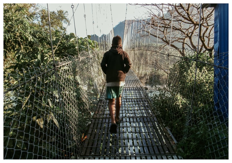 This is my friend walking on a bridge near my school. It leads to Jajarkot. Birendra, 13